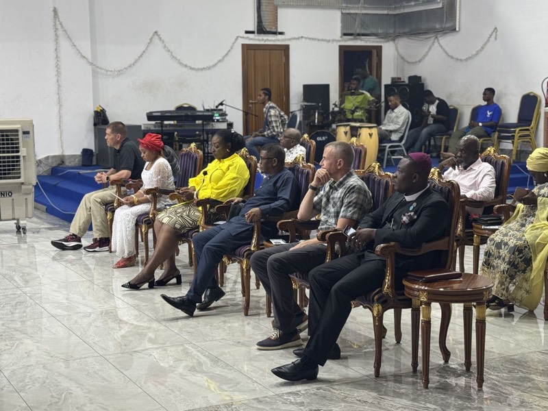 Leaders seated facing the front of a hall at a conference