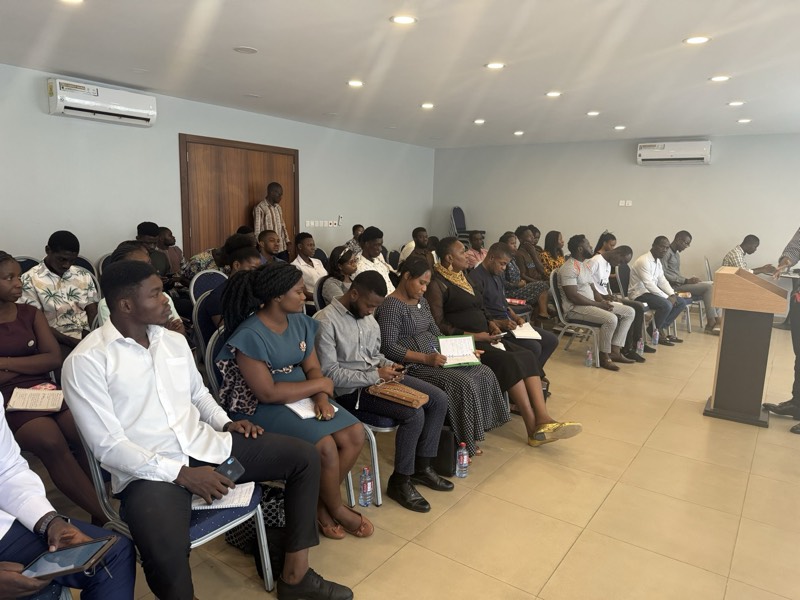 An audience seated in a hall for a session