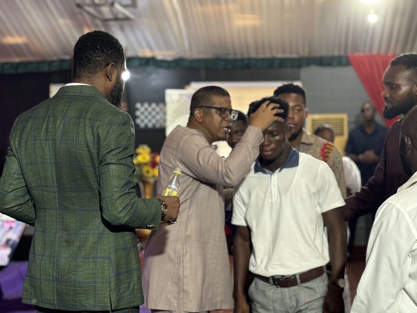 Hands laid on candidates during an ordination