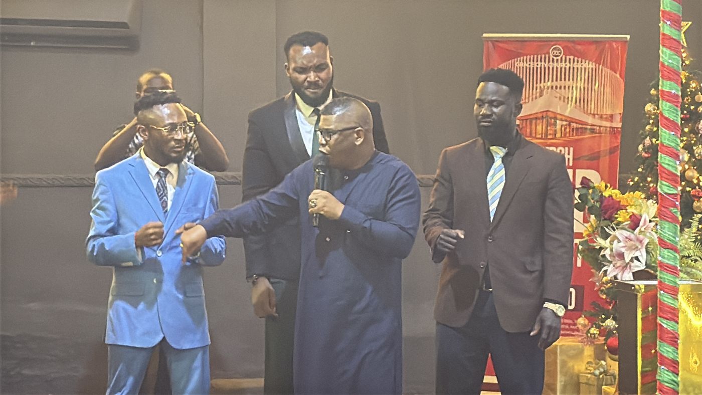 Ministers on a stage praying